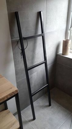 a ladder leaning against the wall in a bathroom