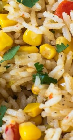 rice and corn are mixed together in a dish that is ready to be eaten on the table