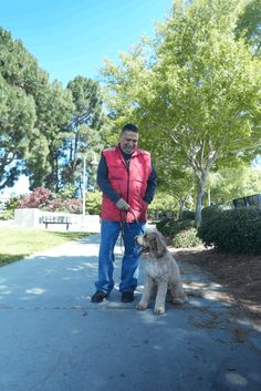 a man is walking his dog on a leash