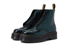 Dr. Martens Sinclair - Women's Boots : Green Wild Croc Emboss : Featuring an allover printed design, the Dr. Martens Sinclair Boots come with an ankle-length construction. Leather upper. Leather and textile lining. Leather and textile insole. Features classic Doc's DNA, including grooved heels, scripted heel loop, and visible yellow stitching. Goodyear welt construction where the upper and sole are heat-sealed and sewn together with the classic Z-welt stitching for long-lasting durability and fl Green Doc Martens, Dr Martens Sinclair Boots, Concert Shoes, Calf Boots Outfit, Croc Outfits, Dr Martens Sinclair, Doc Marten Boot, Dr Martens Womens, Doc Martens Boots