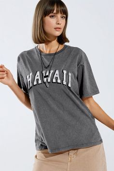 Embrace laid-back style with our Grey Washed Effect Hawaii T-Shirt, a versatile wardrobe staple that adds a touch of effortless charm to any ensemble. Crafted with care in Italy, this relaxed crewneck t-shirt offers both comfort and style in equal measure.  The soft grey hue and washed effect lend a casual vibe to this t-shirt, making it a perfect match for every outfit in your wardrobe. Whether you're dressing up for a day out or keeping it casual at home, this t-shirt is sure to become a favorite go-to piece.  Adding a touch of personality, the front of the shirt features the word "Hawaii" written in white with a black outline, adding visual interest and a hint of tropical flair. The crew neckline and short sleeves ensure versatility, allowing you to wear this t-shirt comfortably through T Shirt Collar, Laid Back Style, Hat Hairstyles, Favorite Jeans, Crew Neckline, Effortless Style, Casual Style, Sweater Top, Womens Tees