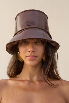 A fur trimmed patent leather reversible bucket hat. — Patent leather — Fur lined — Reversible Leather Bucket Hat, Reversible Bucket Hat, Swimming Bag, Cult Gaia, Leather Bucket, Kids Sandals, Leather Jewelry, Lifestyle Brand, Fur Trim