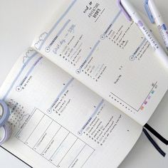 an open planner with two rolls of tape next to it