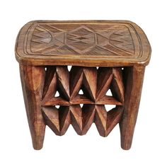 a small wooden table with geometric designs on the top and bottom, sitting against a white background