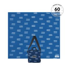 a blue and black bag sitting on top of a blue wall with white lines in it