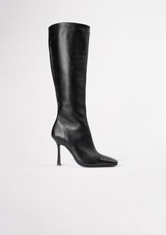 Lending a sleek aesthetic and modern vibes, the Havana knee-high boot is set to impress this AW21. Featuring a slender stiletto heel, an on-trend squared toe and a sleek fitted upper. As a zip-up boot, this style finishes just below the knee. Pair with tucked in pants or a midi-skirt for your next go-to. -Material: ALL NEW Leather Upper & Lining -Sole: Resin sole -Fit: Runs true to size -Toe-shape: Squared -Features: Inner matching zip -Heel: 10.5cm stiletto heel Leg Height x Calf Circumfere Shop Boots Online, Black Patent Heels, Shop Boots, Cork Heels, Patent Heels, Tony Bianco, Calf Boots, Stiletto Heel, Havana