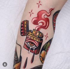 a person with a tattoo on their leg has a hot dog and ketchup