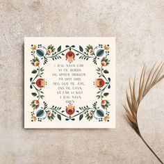 a card with a quote on it next to a plant