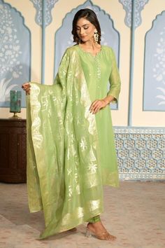 Light green tissue kurta featuring with sequins and mirror work on placket and all-over floral woven motifs. Comes with heavy Banarasi bordered dupatta and matching pant. - Aza Fashions Green Raw Silk Salwar Kameez With Mirror Work, Pista Green Raw Silk Dupatta With Mirror Work, Green Tissue Silk Dupatta For Navratri, Green Slub Silk Dupatta With Mirror Work, Green Unstitched Suit With Mirror Work For Festive Occasions, Festive Pista Green Kurta With Mirror Work, Green Mirror Work Dupatta, Transitional Green Kurta With Mirror Work, Green Art Silk Salwar Kameez With Mirror Work