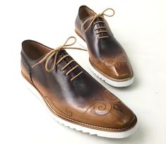 Buy TucciPolo Mens Exclusive Handmade Italian Leather two tone Brown Oxford Style Casual Sneaker Dress Shoes. This pair offers superior comfort and exquisite design. Its Elegant, classic, durable and very comfortable. Buy now with Affirm at checkout and pay in 3-12 months with no hidden fees. Leather : Hand polish Italian calf skin Leather Sole: Eva SoleColor: Two tone brown This is a made-to-order product. Each pair will be made upon receipt of order and shipped in approximately 15 days. Becaus Designer Brown Leather Shoes With Contrast Sole, Luxury Brown Dress Shoes With Contrast Sole, Brown Leather Cap Toe Shoes With Contrast Sole, Formal Brown Lace-up Custom Sneakers, Brown Low-top Dress Shoes With Contrast Sole, Brown Custom Wingtip Sneakers With Contrast Sole, Brown Wingtip Sneakers With Contrast Sole, Formal Brown Wingtip Custom Sneakers, Designer Brown Plain Toe Oxfords