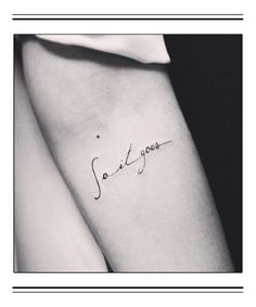 a woman's arm with the word tattoo on it