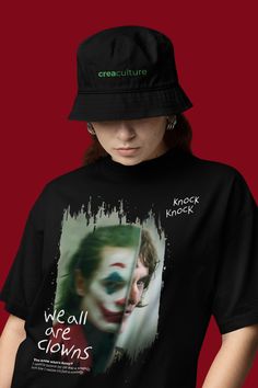 a woman wearing a black hat and t - shirt with the joker movie poster on it