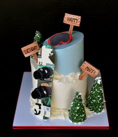 a birthday cake with skis and snowboards on the top is made to look like it has been decorated