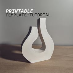 a white vase sitting on top of a wooden table next to a gray wall with the words printable template