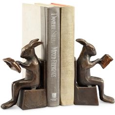 a bookend that has two books on it and one is holding a rabbit figurine