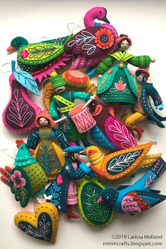 many colorful birds are sitting on top of each other in the shape of flowers and leaves