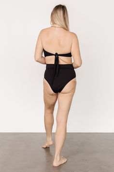 Baltic Born best-seller! Classic Black High waist style bikini bottom Adjustable front wrap tie detail Moderate coverage 80% Nylon, 20% Spandex Hand wash cold Trina is 5'6, cup size 32D, size 2 and is wearing size S Victoria is 5'7, cup size 34D, size 8/10 and wearing size L Chic Beach Bottoms With Built-in Bra, Beachwear Bottoms With Built-in Bra For Beach Season, High Waist Tankini With Built-in Bra For Poolside, Tie-side Bottom Swimwear With Built-in Bra For Sunbathing, High Waist Swimwear With Built-in Bra For Pool, Tankini With Built-in Bra And Tie-side Bottom For Poolside, Beachwear Tankini With Built-in Bra And High Waist, Solid Color Seamless Swimwear With Tie-side Bottom, Poolside Swimwear With Built-in Bra And Tie-side Bottom