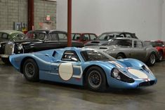 an old race car is parked in a garage