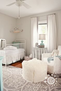 a baby's room with two cribs and a large rug on the floor