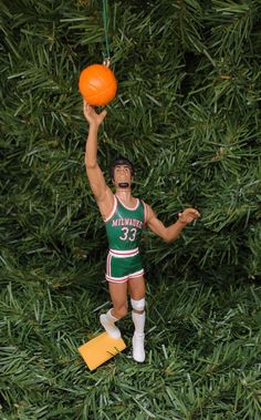 a figurine is holding a basketball in the air