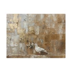 a white bird sitting on top of a stone wall next to a green leafy plant