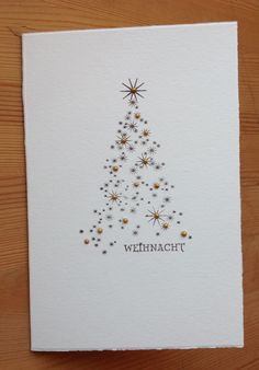 a white card with a christmas tree on it and the words weinhacht written in german