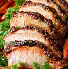 sliced pork with sauce and parsley on a plate