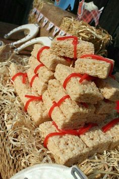 some kind of food that is on a table with straw and red ribbon around it