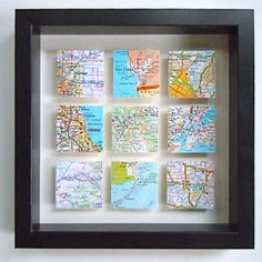 a black frame holds maps and magnets on the wall