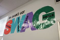 an office wall with the word swag on it's side and various stickers