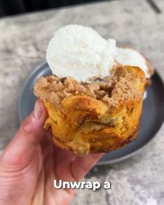 a hand holding up a pastry with ice cream on top and the words unwrapp above it