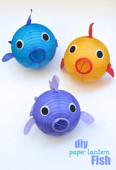 three paper lanterns shaped like fish on a white background with text overlay that reads, fish paper lanterns by make life lovely