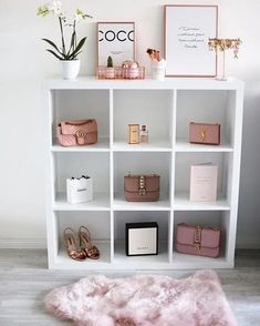 a white book shelf filled with lots of purses and bags on top of it