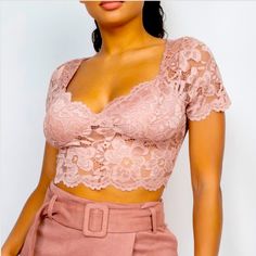 A Dusty Blush Knit Cropped Floral Lace Top Featuring A Scalloped Hem, Sweetheart Neckline, And Short Sleeves. Category: Tops Fabric: 80% Nylon, 20% Spandex Content: 80% Nylon, 20% Spandex S(4-6) M(8-10) L(12-14) Pink Fitted Lace Top, Beige Lace Fitted Crop Top, Fitted Beige Lace Crop Top, Fitted Lace Beige Crop Top, Trendy Pink Lace Tops, Beige Fitted Lace Tops, Chic Fitted Pink Crochet Top, Feminine Fitted Crochet Top For Party, Trendy Fitted Beige Crochet Top