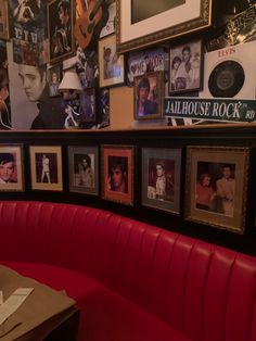 a red booth with pictures on the wall and tables in front of it, along with other memorabilia