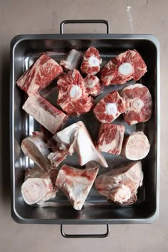 raw meat in a metal pan on a table