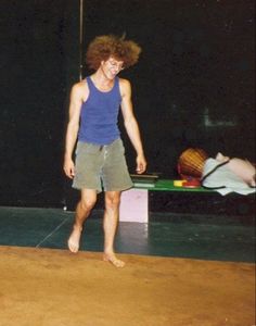 a young man standing on top of a wooden floor