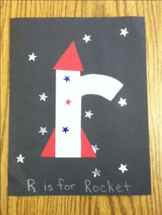 the letter i is for rocket painted on a piece of paper with stars around it