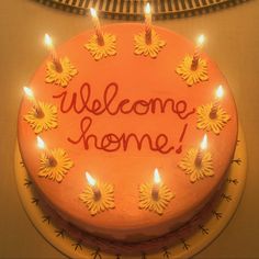 a cake with candles on it that says welcome home