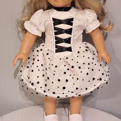 Your doll will look fabulous in this special polka dot dress! * Doll outfit contains hook and loop fastener for easy dressing and clothing removal * Satin bodice with a mesh overlay skirt * Contrasting black thread * The doll clothes fits 18 inch American Girl dolls, or equivalent dolls * Based on the Tutu Cute pattern on PixieFaire * Handmade in the US - smoke-free home * Doll and accessories not included Fitted Polka Dot Dress For Costume Party, Overlay Skirt, Polka Dot Shorts, Black Thread, Dot Dress, Polka Dot Dress, White Polka Dot, Cute Pattern, Simple Dresses