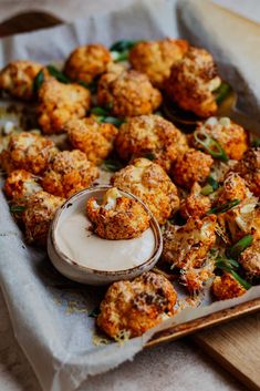 some food is sitting on a tray and ready to be eaten with sauce in it