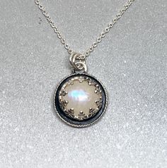 This rainbow moonstone has a lovely shimmer and pretty plump shape! The classic circle shape and dark oxidation give the pendant a timeless look that is easy to wear. Layer with your other gemstone necklaces or wear on its own for a minimalist look! This moonstone charm is 1/2" diameter and will come on a 16" or 18" solid sterling silver chain of your choosing. Crafted in solid silver with a natural, untreated moonstone. Makes a wonderful gift! 💎 Here is a beautiful layering pendant with amethy Rainbow Moonstone Jewelry, Rainbow Moonstone Pendant, Moonstone Necklace, Moonstone Jewelry, Moonstone Pendant, Circle Necklace, Circle Shape, Rainbow Moonstone, Minimalist Jewelry