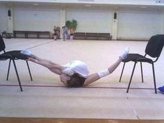 a woman laying on her back in a gym