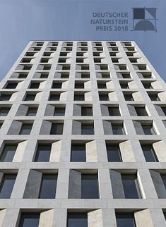 a tall building with lots of windows on it's side and sky in the background