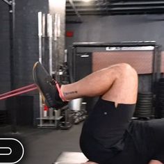 a man laying on top of a bench in a gym