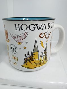 a harry potter mug with hogwart's castle on it