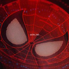 a close up view of the eyes of a spider - man in red and black