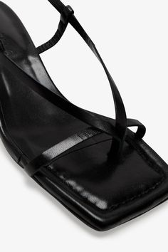 Strappy sophistication. Our Greta Sandals feature a modern square toe and an adjustable slingback strap for a flattering look, enhanced by a chic kitten heel and minimalist raw edges. Whether it's running between meetings or dancing the night away, their padded soles and soft Italian leather let you do it all in comfort—and impeccable style.[SPLIT] Astrid wears Greta in black, in cream, and in disco. Heel height is approximately 2" (5 cm). Sold in US sizes, though please note that shoes may be l Sleek Evening Slingback Sandals With Heel Loop, Sleek Open Heel Kitten Heels For Spring, Sleek Slingback Pumps For Summer, Sleek Summer Slingback Pumps, Sleek Fitted Slingback Pumps For Summer, Summer Evening Slingback Pumps With Padded Heel, Sleek Slingback Kitten Heels For Spring, Elegant Synthetic Square Toe Slingback Sandals, Sleek Summer Slingback Pumps With Padded Heel