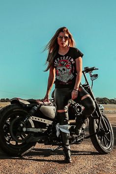 a woman sitting on top of a motorcycle