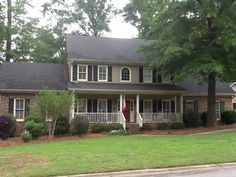 a large house sitting on the side of a road